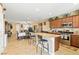 Spacious open-concept kitchen with a central island, stainless steel appliances, and dark wood cabinets at 2612 Tullamore Creek Ln, Laughlin, NV 89029