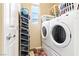 Bright laundry room features a stacked washer and dryer and shoe rack, maximizing space and efficiency at 2612 Tullamore Creek Ln, Laughlin, NV 89029