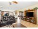 Living room featuring tile floors, a large TV console, and comfortable seating at 2612 Tullamore Creek Ln, Laughlin, NV 89029
