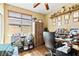 Cozy office space with a window, wooden desk, bookshelves, and decorative items for inspiration at 2612 Tullamore Creek Ln, Laughlin, NV 89029