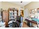 Comfortable office with wooden desk, built-in shelves, and a door to an adjoining room at 2612 Tullamore Creek Ln, Laughlin, NV 89029