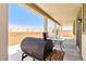 A spacious covered patio with a grill and outdoor furniture, perfect for enjoying the backyard at 2612 Tullamore Creek Ln, Laughlin, NV 89029