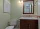 Cozy powder room featuring a toilet, vanity with sink and mirror, perfect for guests at 3189 Pinehurst Dr # B, Las Vegas, NV 89109
