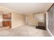 Spacious, carpeted living room with stairway and neutral color scheme at 3189 Pinehurst Dr # B, Las Vegas, NV 89109