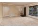 Beige living room with neutral carpet, stairwell and large window with natural light at 3189 Pinehurst Dr # B, Las Vegas, NV 89109