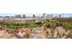 The property is surrounded by lush landscaping, mature trees, and a golf course with a backdrop of city buildings at 3207 Bel Air Dr, Las Vegas, NV 89109