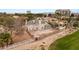 Aerial view shows property surrounded by golf course, mature trees and landscaping, and a city skyline at 3207 Bel Air Dr, Las Vegas, NV 89109