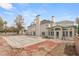 Large backyard featuring a brick patio and a covered pool area, with an attached sunroom and lush landscaping at 3207 Bel Air Dr, Las Vegas, NV 89109