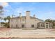 Backyard view featuring a covered pool, brick patio, lush landscaping and a beautiful two-story home at 3207 Bel Air Dr, Las Vegas, NV 89109
