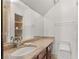Bathroom with a modern sink, granite countertop, wood cabinet, and toilet at 3207 Bel Air Dr, Las Vegas, NV 89109