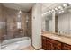 Contemporary bathroom featuring marble finishes, glass enclosed shower and tub combo for a serene space at 3207 Bel Air Dr, Las Vegas, NV 89109