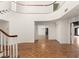 Spacious foyer features an elegant curved staircase, wood flooring, and high ceilings at 3207 Bel Air Dr, Las Vegas, NV 89109