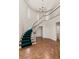 Elegant foyer with a curved staircase, hardwood floors, and a chandelier at 3207 Bel Air Dr, Las Vegas, NV 89109