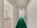 Hallway with green carpet, white walls, and recessed lighting, leading to carpeted room at 3207 Bel Air Dr, Las Vegas, NV 89109
