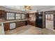 Bright kitchen with wood cabinets, granite countertops, tile flooring, and a view of an adjacent room at 3207 Bel Air Dr, Las Vegas, NV 89109