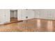 Open living room with hardwood floors, white walls, and large windows at 3207 Bel Air Dr, Las Vegas, NV 89109
