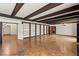 Expansive living room with wooden beams, hardwood floors, built-in bookshelves, and a fireplace at 3207 Bel Air Dr, Las Vegas, NV 89109