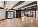Spacious living area with wooden beams, hardwood floors, a fireplace, and multiple entry points at 3207 Bel Air Dr, Las Vegas, NV 89109