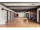 Large living room with exposed beams, built-in shelves, a fireplace, and wood floors at 3207 Bel Air Dr, Las Vegas, NV 89109