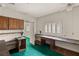 Room with custom built-in desk and cabinet storage spaces with green carpet at 3207 Bel Air Dr, Las Vegas, NV 89109