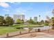 Scenic view of a golf course, pond, and the city skyline in the distance, with a brick patio in the foreground at 3207 Bel Air Dr, Las Vegas, NV 89109