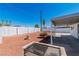 Landscaped backyard with a covered patio and an outdoor grill at 3212 Hickey Ave, North Las Vegas, NV 89030