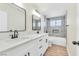 Modern bathroom with double vanity, quartz countertop, and tiled shower over tub at 3212 Hickey Ave, North Las Vegas, NV 89030