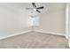 This bedroom has plush carpet, a ceiling fan, and a window for natural light at 3212 Hickey Ave, North Las Vegas, NV 89030