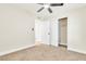 Bedroom features closet with sliding doors, neutral carpet and a ceiling fan at 3212 Hickey Ave, North Las Vegas, NV 89030