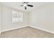 Cozy bedroom with neutral carpet, a ceiling fan, and a window at 3212 Hickey Ave, North Las Vegas, NV 89030