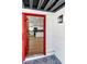Inviting entryway featuring a red door, black and white patterned tile, and a glimpse into the updated kitchen at 3212 Hickey Ave, North Las Vegas, NV 89030