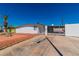 Exterior view showcasing the home's facade and driveway with gated access to backyard at 3212 Hickey Ave, North Las Vegas, NV 89030