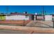 Single-story home with a fenced front yard, driveway parking, and mature trees adding character at 3212 Hickey Ave, North Las Vegas, NV 89030