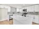 Contemporary kitchen with white cabinetry, stainless steel appliances, and quartz countertops, offering an island for extra space at 3212 Hickey Ave, North Las Vegas, NV 89030