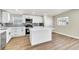 Stylish kitchen with white cabinets, stainless steel appliances, an island, and modern fixtures for a sleek design at 3212 Hickey Ave, North Las Vegas, NV 89030