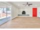 Bright living room featuring wood floors, fireplace, and sliding glass doors to the backyard at 3212 Hickey Ave, North Las Vegas, NV 89030