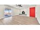 Spacious living room with a sliding glass door, fireplace, and light wood floors, bathed in natural light at 3212 Hickey Ave, North Las Vegas, NV 89030