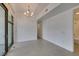 Open living area featuring modern chandelier, gray tile floors, and natural light at 353 E Bonneville Ave # 289, Las Vegas, NV 89101