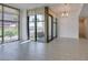 Bright living area featuring tile floors, modern lighting, and a sliding glass door to a balcony at 353 E Bonneville Ave # 289, Las Vegas, NV 89101