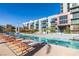 Inviting poolside area featuring a long in-ground pool and many lounge chairs at 353 E Bonneville Ave # 289, Las Vegas, NV 89101