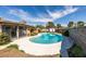 Backyard featuring a pristine in-ground pool surrounded by a concrete patio and mature trees at 4476 Oakhill Cir, Las Vegas, NV 89121
