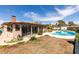 Backyard boasts a pool with patio, large sunroom, and mature trees at 4476 Oakhill Cir, Las Vegas, NV 89121