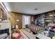 Bedroom with wood paneling, a double bed, built-in shelving, and an area rug at 4476 Oakhill Cir, Las Vegas, NV 89121