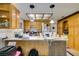 Traditional kitchen featuring light wood cabinets, white countertops and a central island with pendant lighting at 4476 Oakhill Cir, Las Vegas, NV 89121