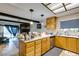 An eat-in kitchen with stainless steel appliances, light wood cabinets, white counters, and an adjoining living space at 4476 Oakhill Cir, Las Vegas, NV 89121