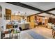 Open concept living space flowing into the kitchen, with wood beams overhead at 4476 Oakhill Cir, Las Vegas, NV 89121
