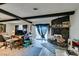 Bright living space with wood beams, stone fireplace, and sliding glass door access at 4476 Oakhill Cir, Las Vegas, NV 89121