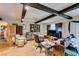 View of the living room, featuring wood floors, exposed beam ceilings, and a variety of comfortable seating at 4476 Oakhill Cir, Las Vegas, NV 89121