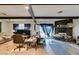 Open living area featuring stone fireplace, wood beams, and bright natural light at 4476 Oakhill Cir, Las Vegas, NV 89121