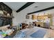 Bright living area flowing into the kitchen, featuring wood beams and ample lighting at 4476 Oakhill Cir, Las Vegas, NV 89121